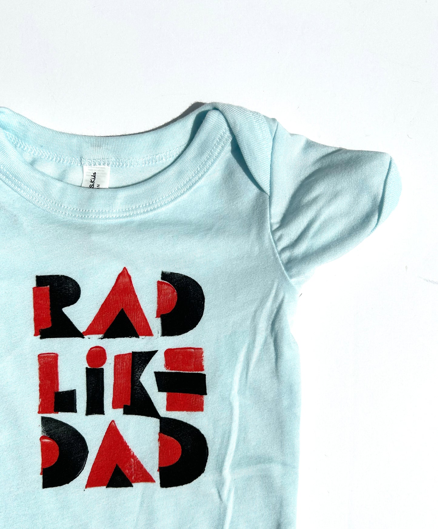 rad like dad  baby one piece: bi-color block print