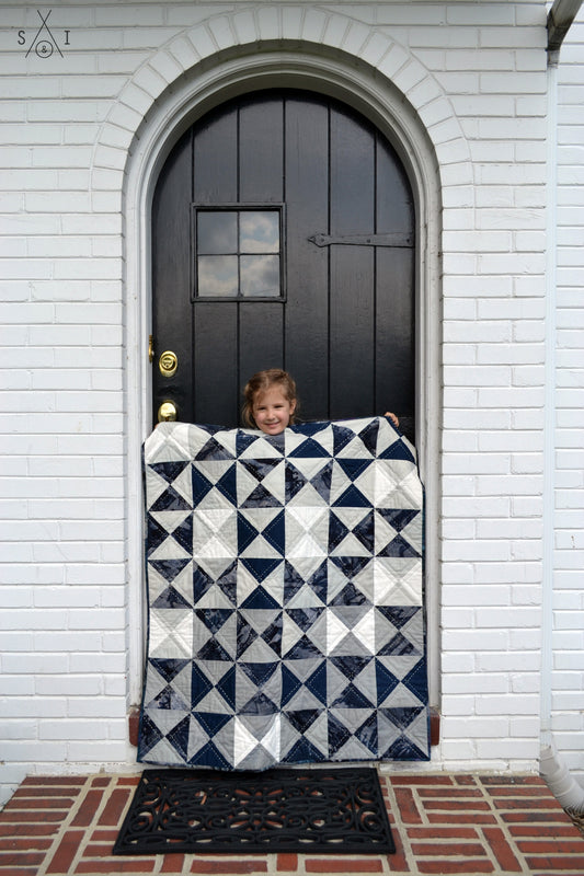 quarter square triangle baby quilt: ombre and blue batik